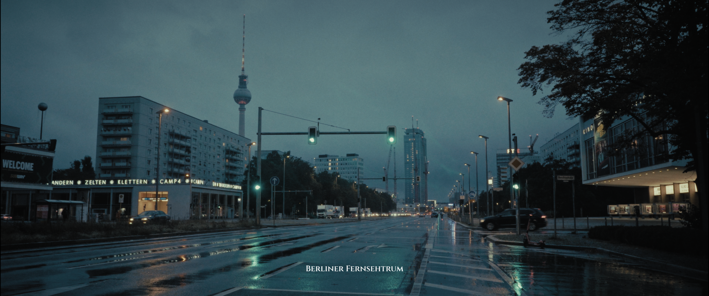 Rainy Berlin street at dusk with the Fernsehturm in the distance