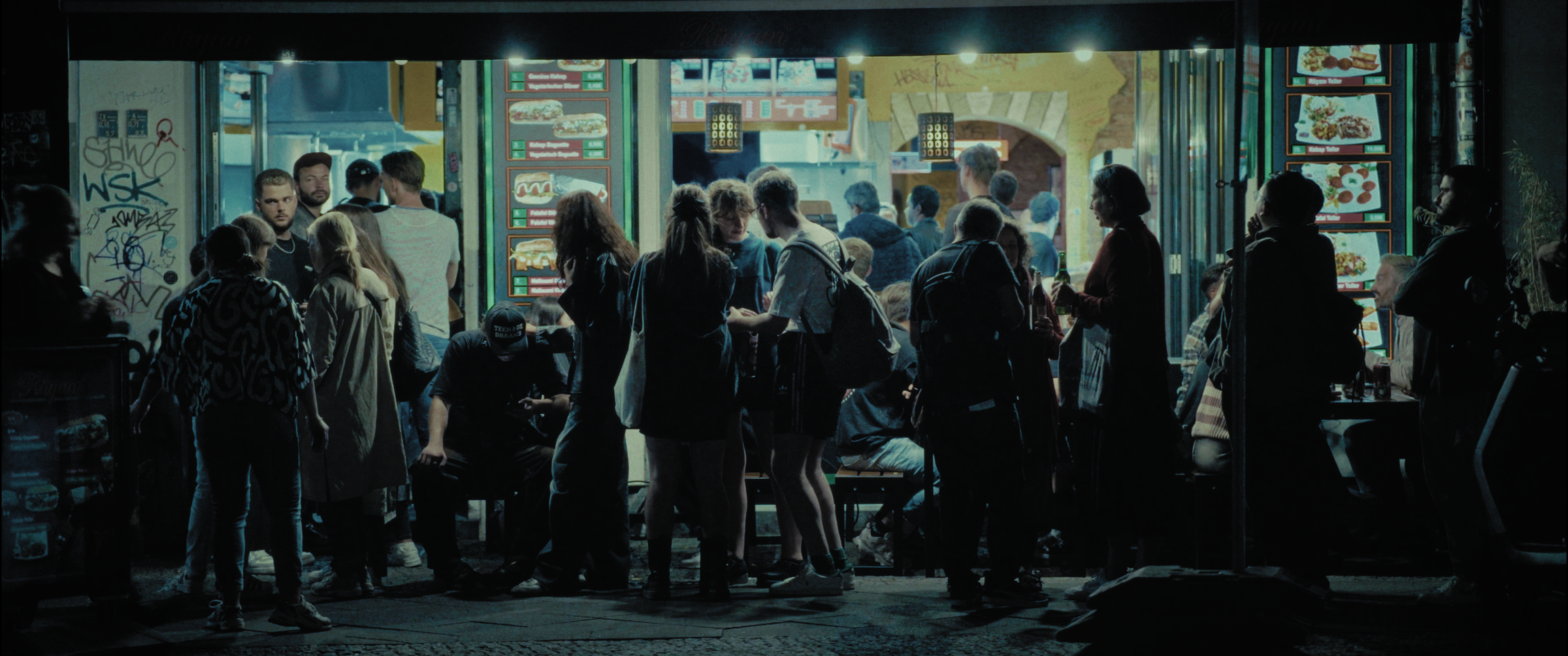 Crowd gathered outside a late-night food kiosk